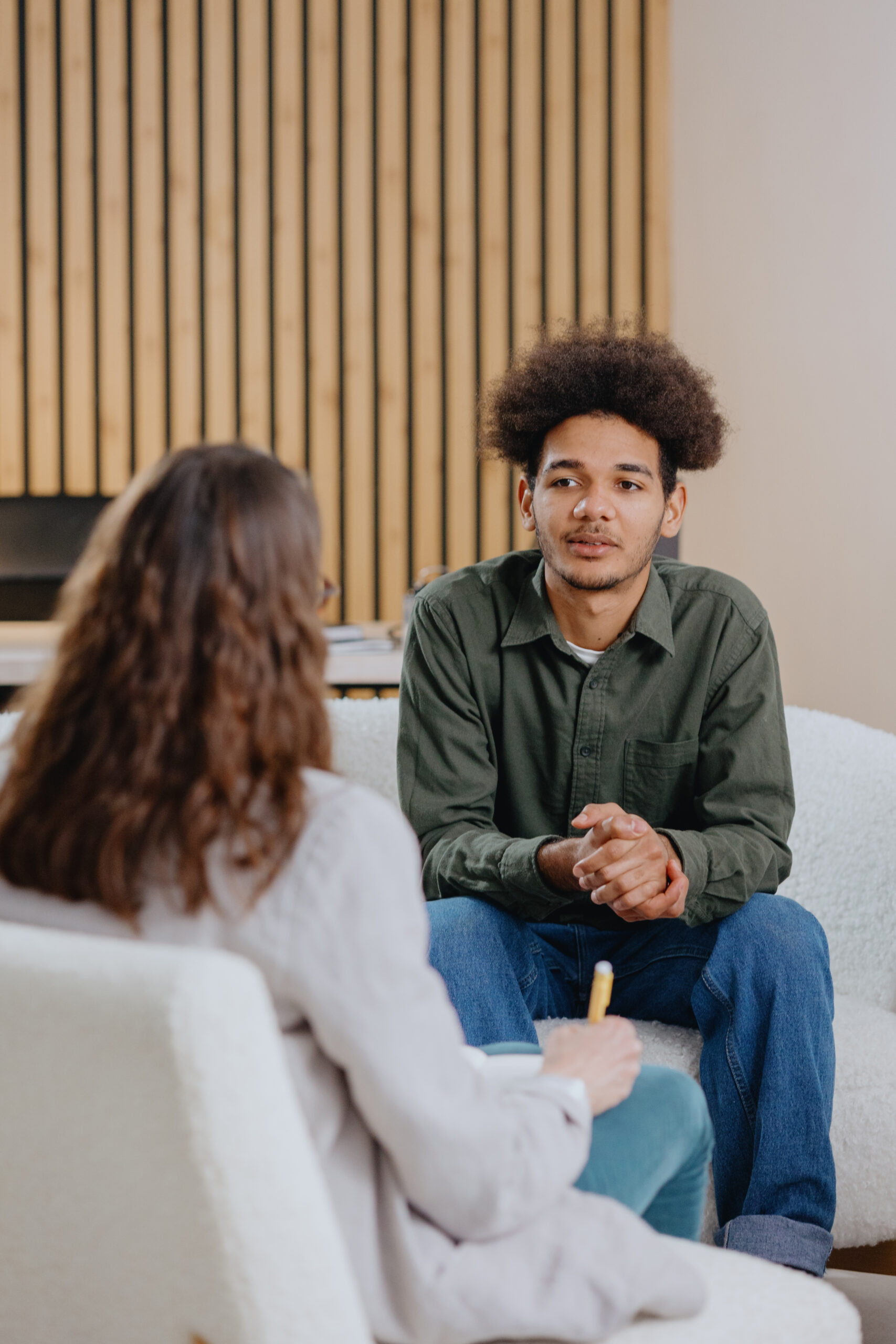 young man in consultation with psychologist is taking care of mental health. Psychotherapy for treatment of disorders and depression, insomnia. African American guy tells doctor about his problems